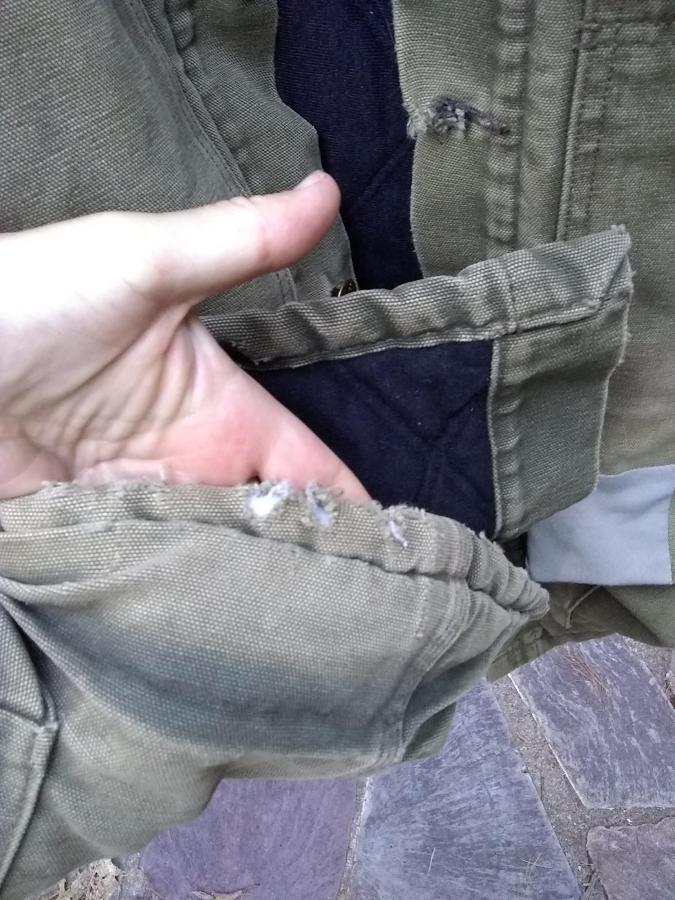 worn fabric on bottom hem of jacket