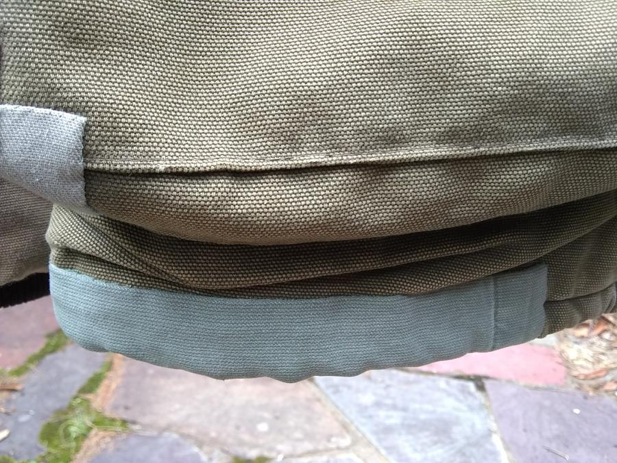 closeup of patches on bottom hem and pocket of Carhartt jacket