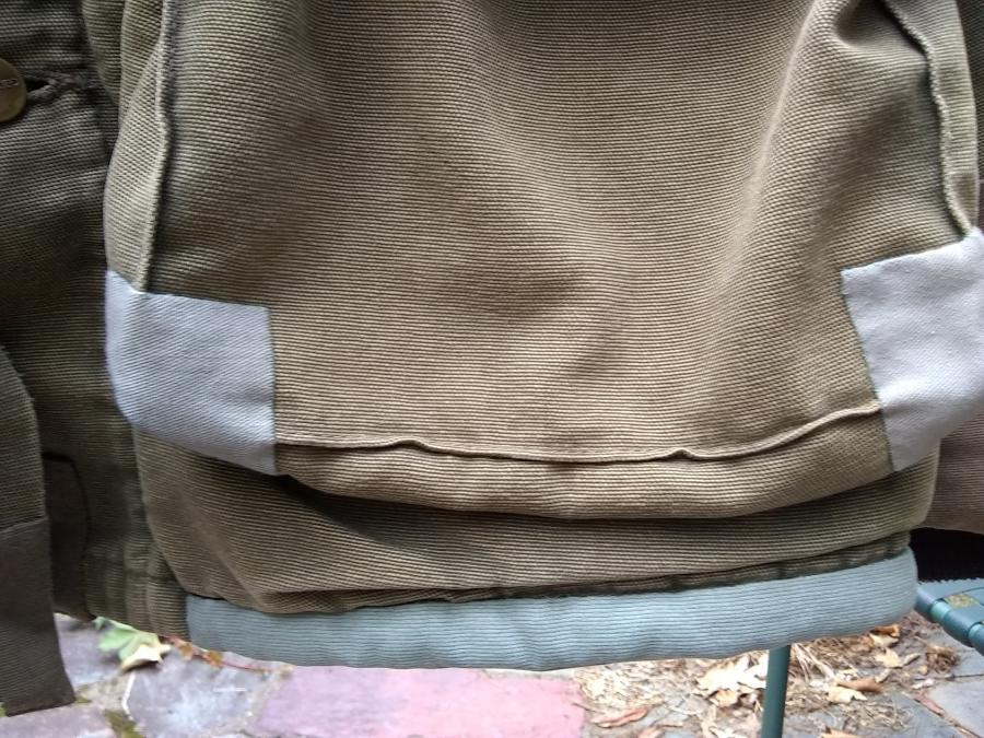 closeup of pocket and bottom hem patches on Carhartt jacket