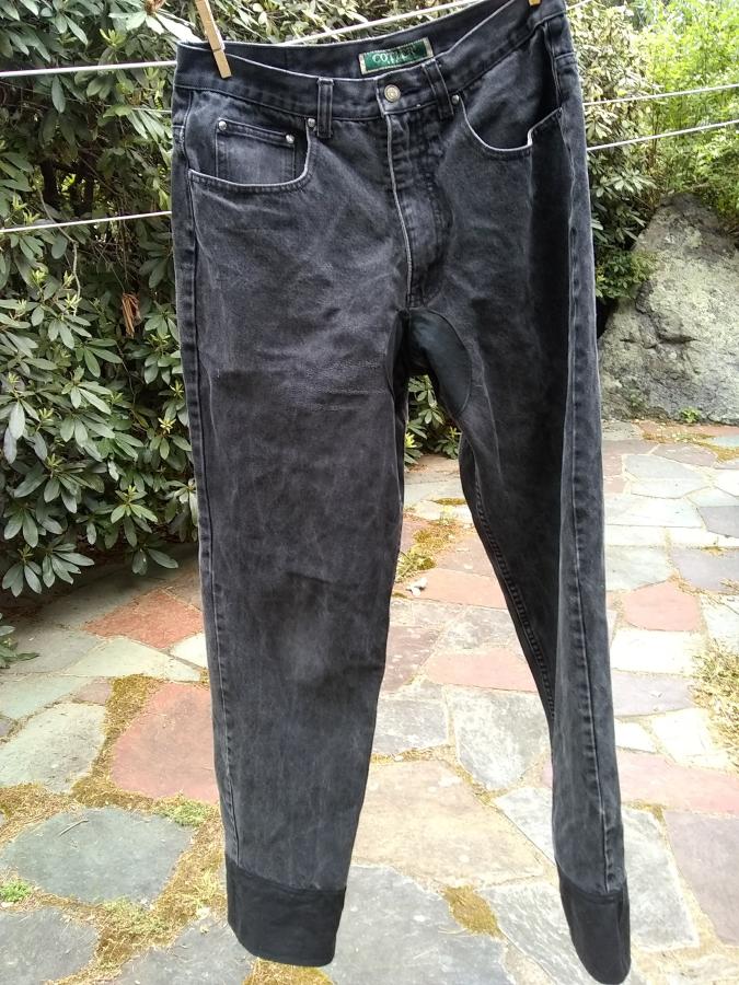 front view on clothesline of black jeans with leg extensions and crotch patch
