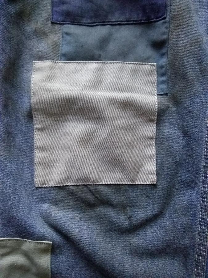 closeup of overlapping patches on blue jeans
