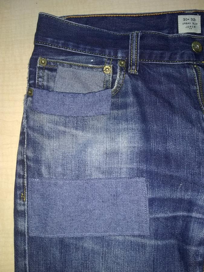 Front of jeans with patched coin pocket, pocket,  and patch on leg