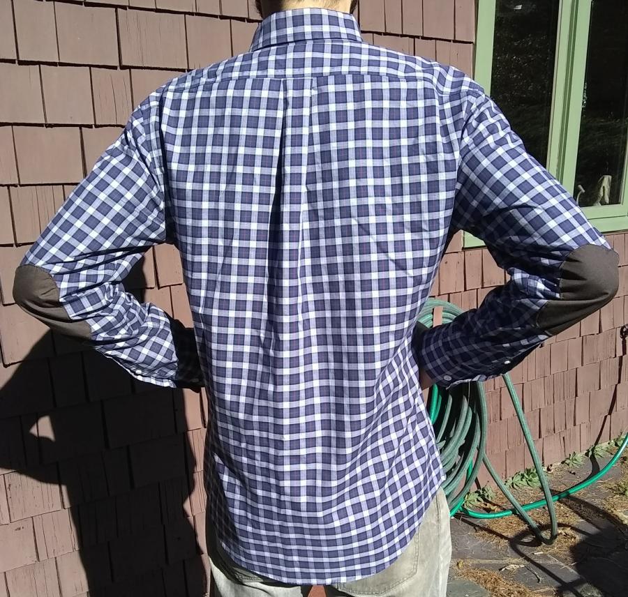 back view with elbows bent of purple plaid shirt with elbow patches worn by man