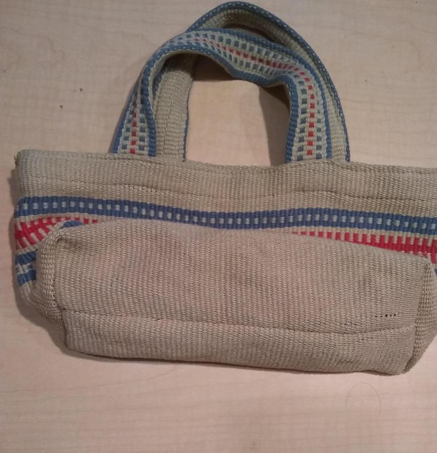 unstained woven bag in good condition (no holes) showing bottom of bag