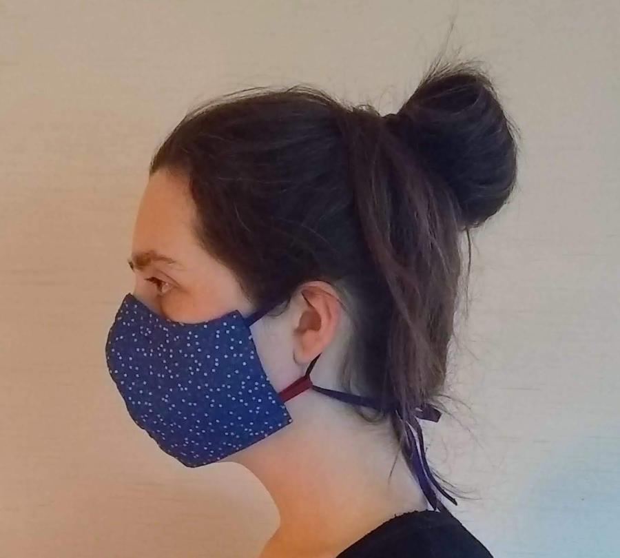 woman wearing fitted face mask with cloth ties, side view