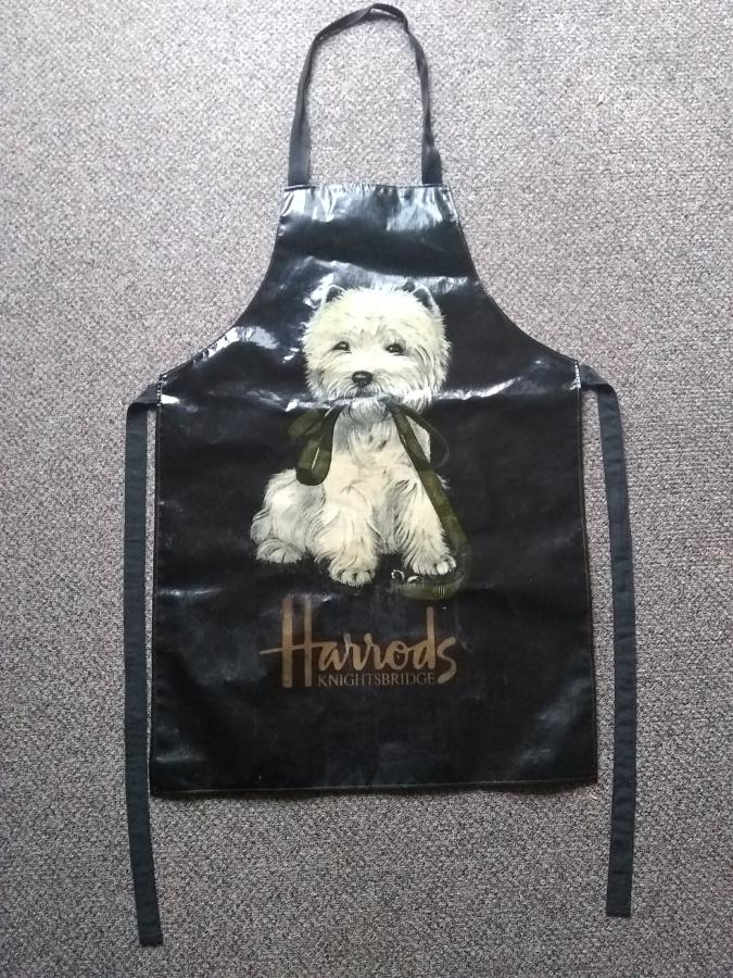 Black apron with dog and "Harrods" on front