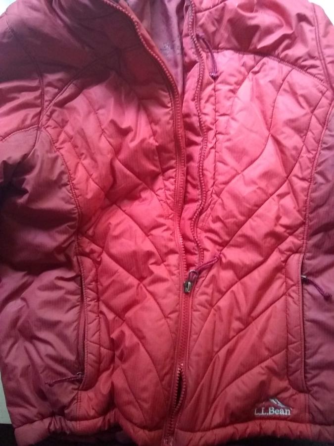 red winter jacket with zipper broken (partially zipped up, but zipper teeth don't stay together)