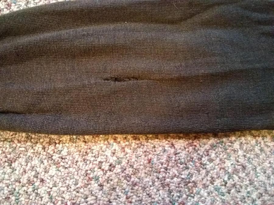 Brown knit sweater sleeve, with hole/run in it