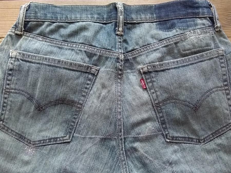 seat of jeans with faint zig-zag lines where interior patches were sewn on