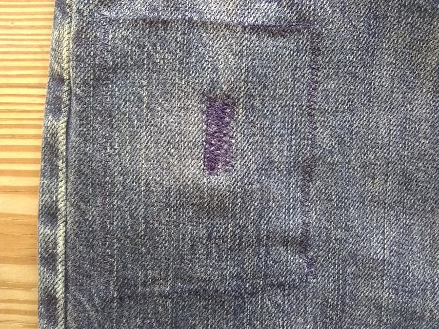 closeup of denim jeans with rectangular machine darning