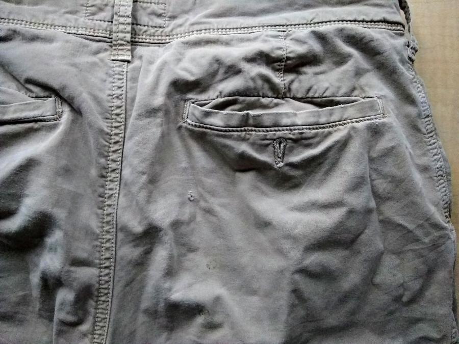 Seat of khaki pants, exterior, showing small holes in fabric