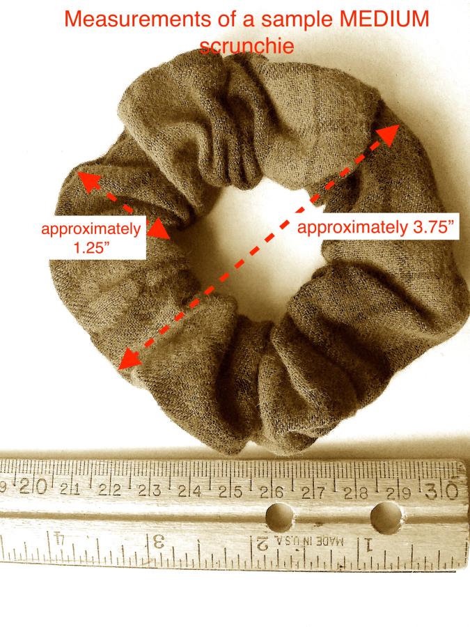 sepia colored medium scrunchie with ruler and annotations to explain the dimensions (3.75" diameter from edge to edge across the "doughnut" and 1.25" from inner to outer edge of the thickness of the "doughnut")