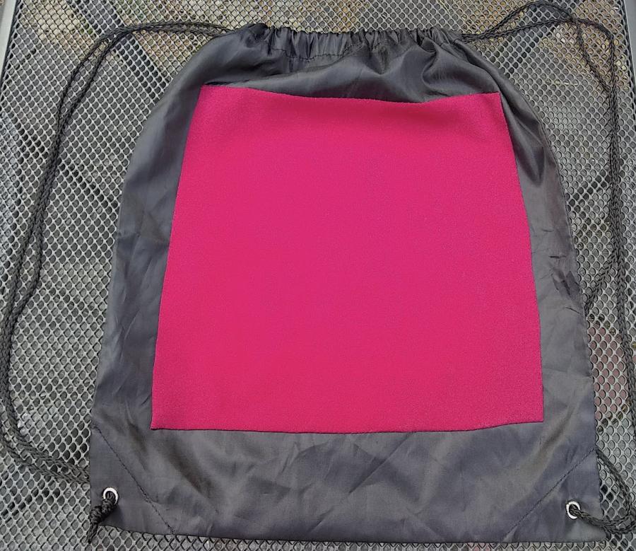 Black cinch bag with large red patch