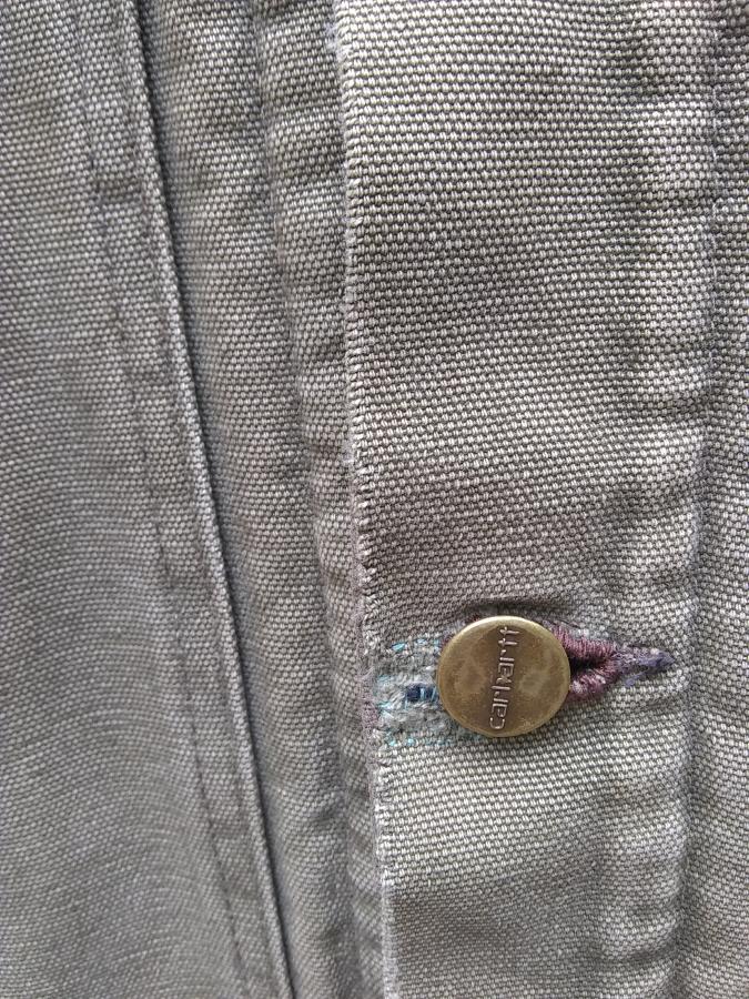 closeup of mended buttonhole on Carhartt jacket