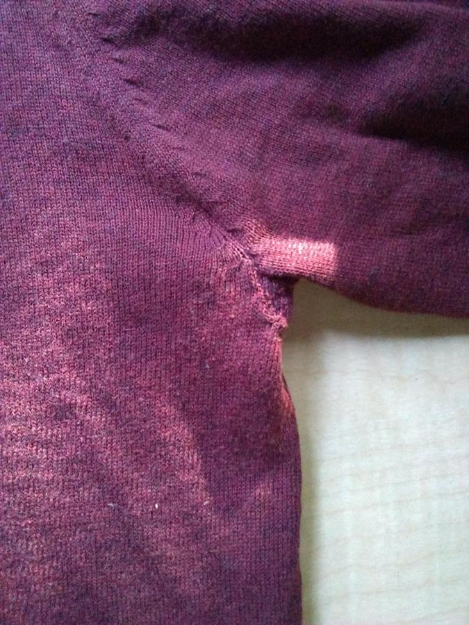 closeup of armpit of maroon sweater with no holes