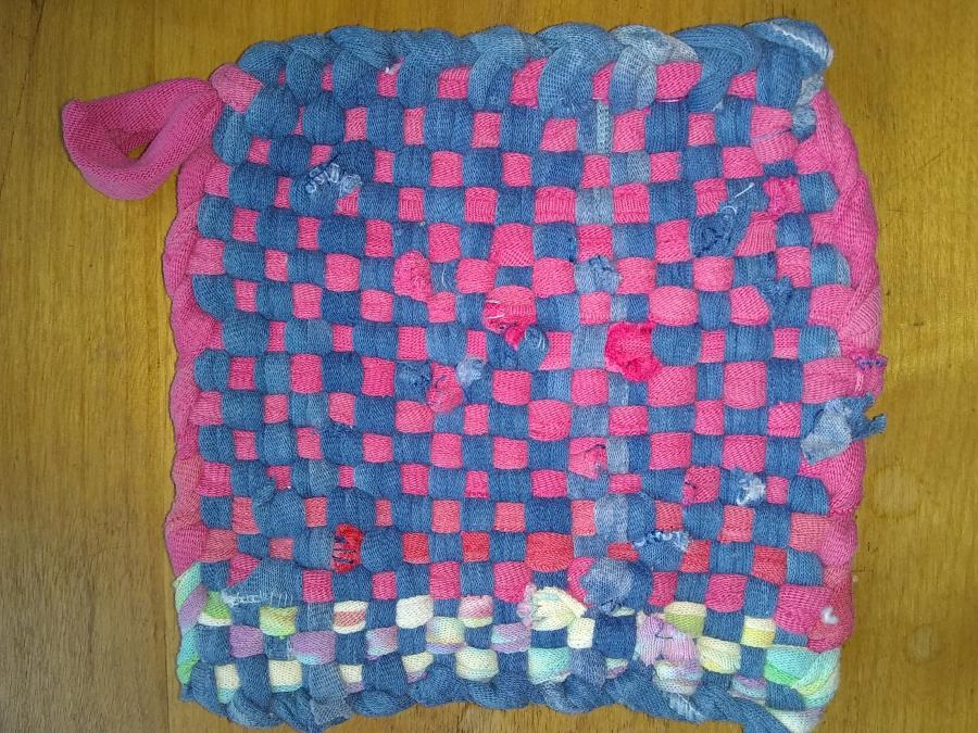 hand woven potholder in blue and pink with some multi