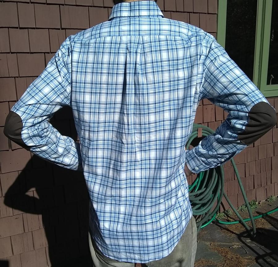 back view with elbows bent of blue plaid shirt with elbow patches, worn by man