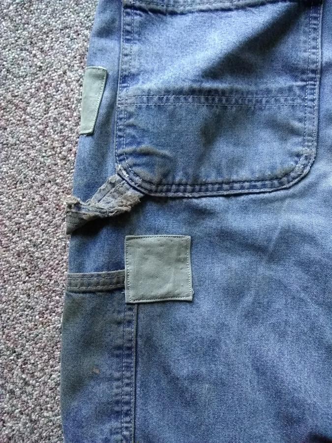 closeup of patches on back of blue jeans
