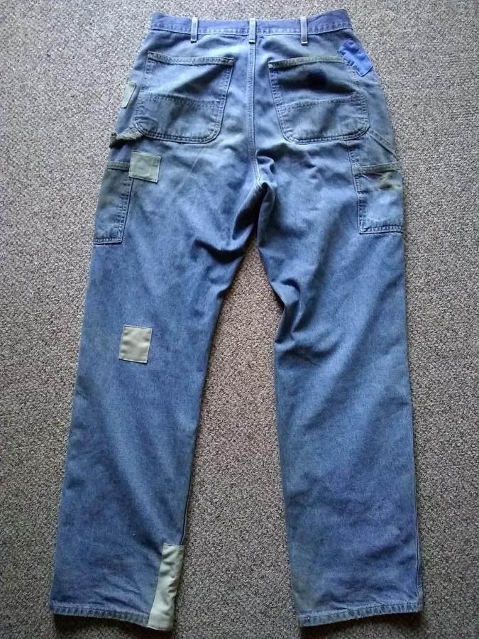 full back view of patched blue jeans