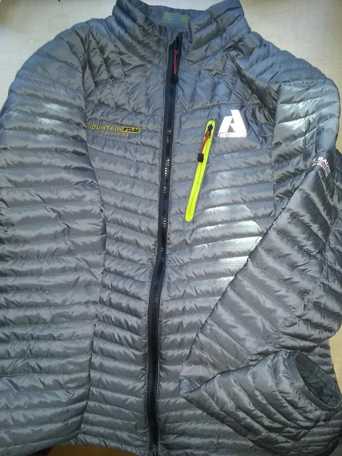 gray down jacket with black zipper, working, zipped up
