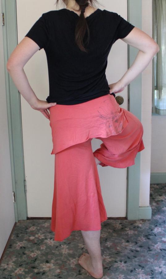 woman wearing pink gaucho pants, back view