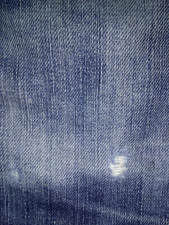 closeup of hole on leg of jeans