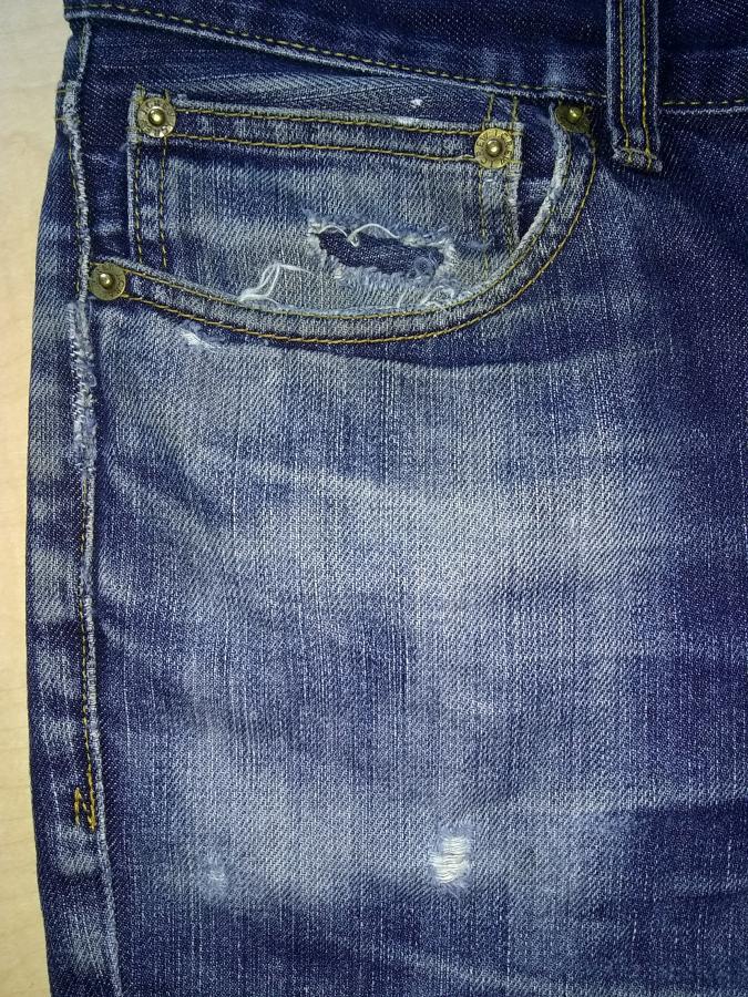 jeans with holes in coin pocket and on leg