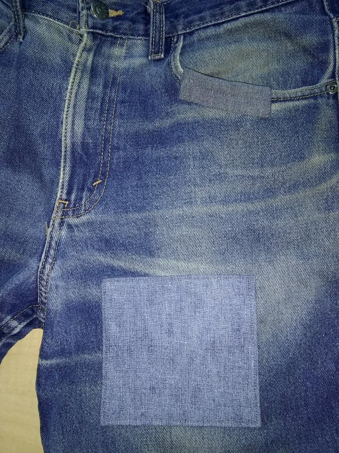 closeup of right side of jeans with patch on upper thigh and pocket