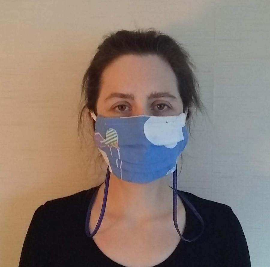 Front view of woman wearing pleated mask with neck cord