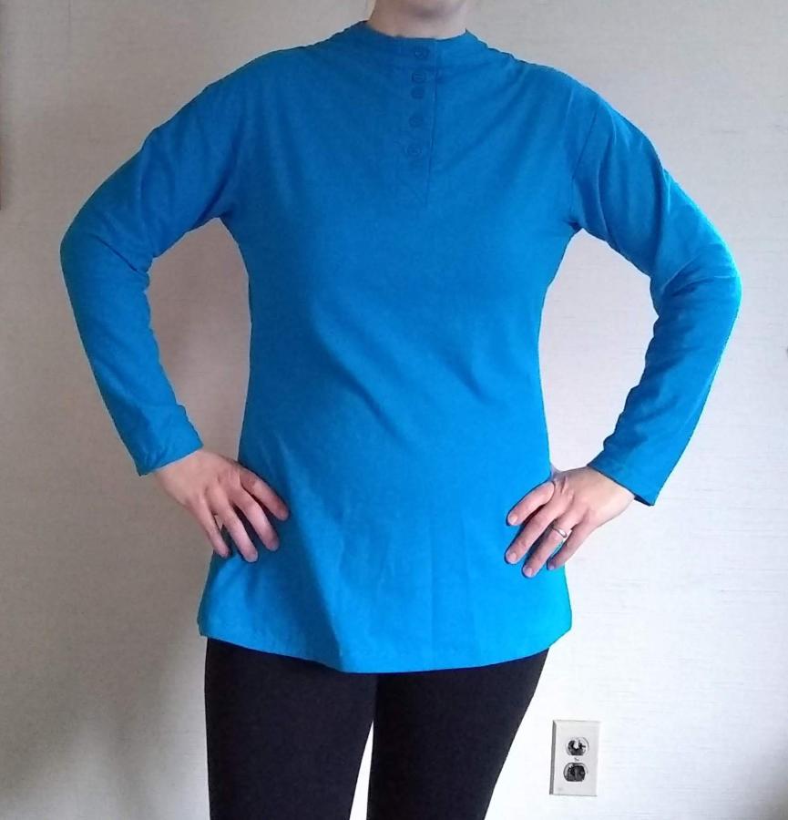 woman's torso wearing long sleeve turquoise henley shirt, tunic length with slightly shaped side seams