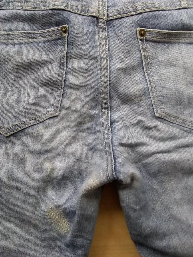 backside of jeans showing machine darning on inner thighs