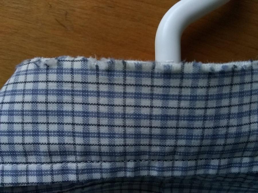 closeup of worn fabric in collar of shirt, back view
