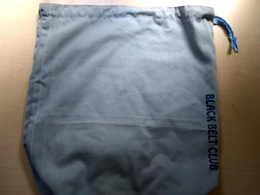 gray bag with blue cloud print drawstring and "Black Belt Club" screenprinting down the side