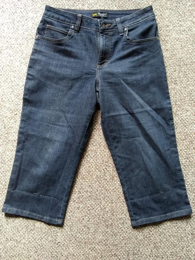 Front view of capri jeans with pins at bottom of legs indicating where to hem