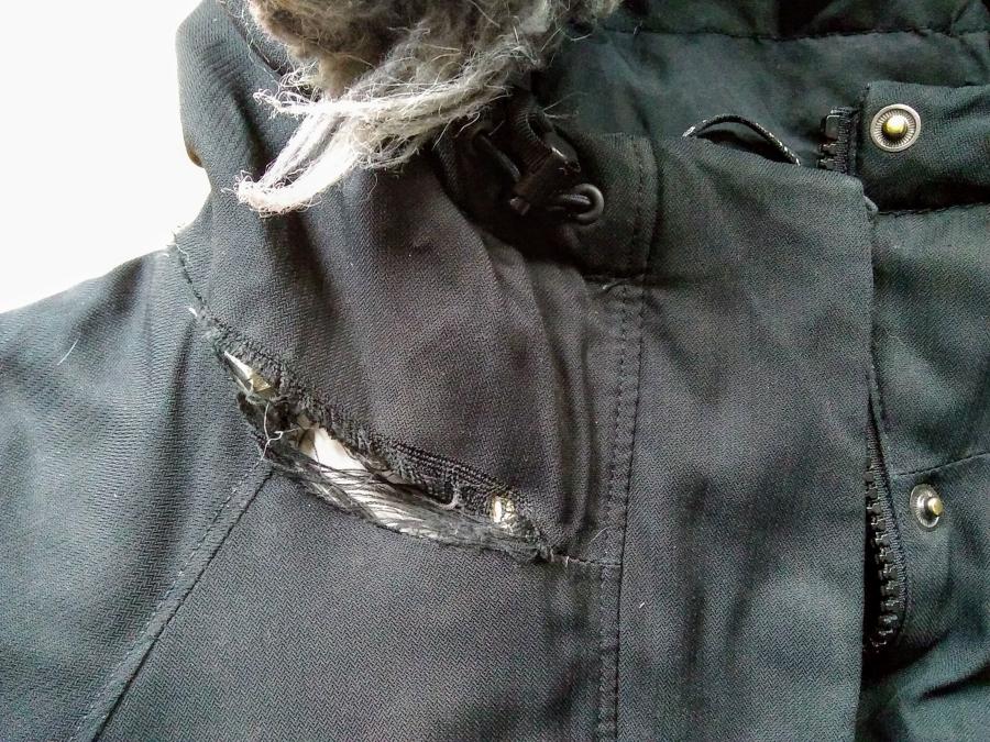 Black winter jacket with rip in the collar