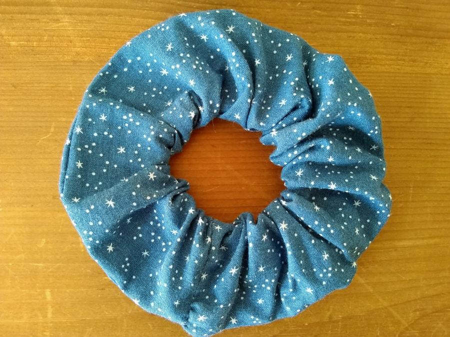 Blue star-print scrunchie on wood background