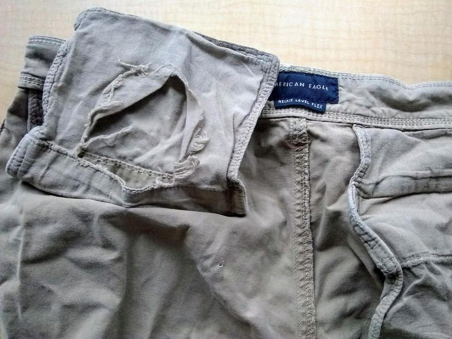 Inside of waist/pocket of khaki pants, showing hole in pocket