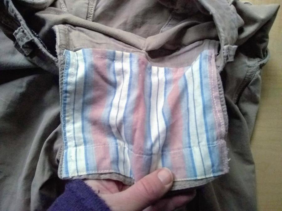 Interior of khaki pants waist/pocket showing contrasting striped pocket patch