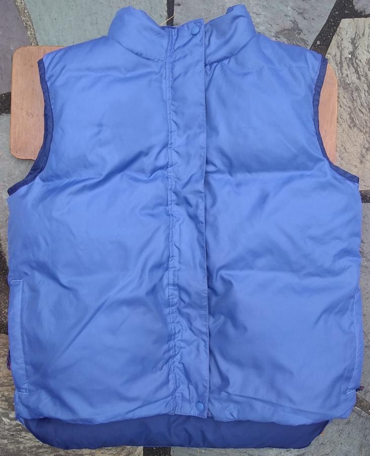 Blue down jacket, fully closed (zipper not visible because it is snapped up)