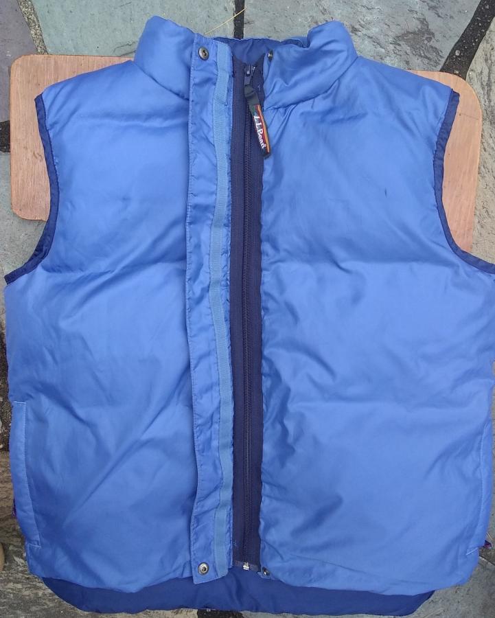 Blue down vest with navy zipper
