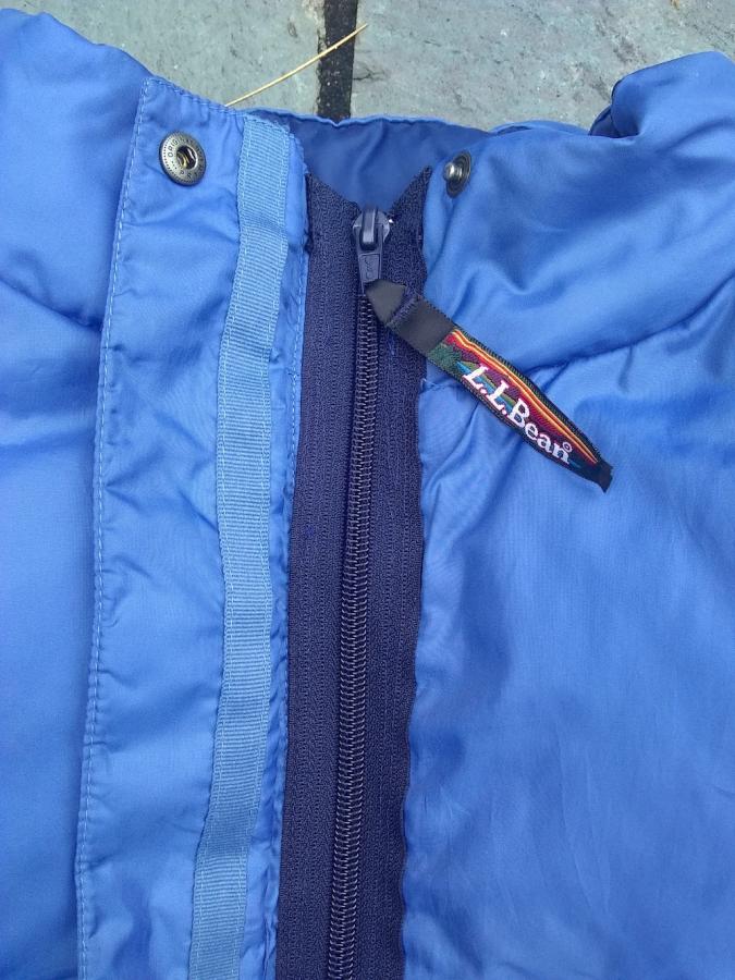 closeup of top of navy zipper in blue vest
