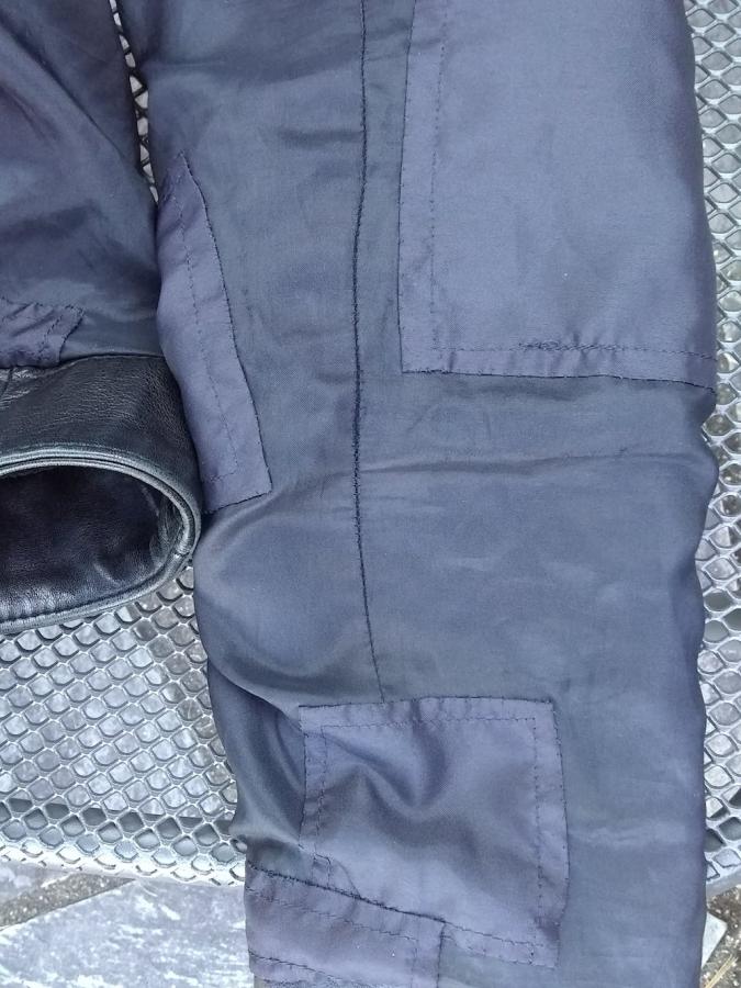 Lining of sleeve of black jacket with multiple matching patches