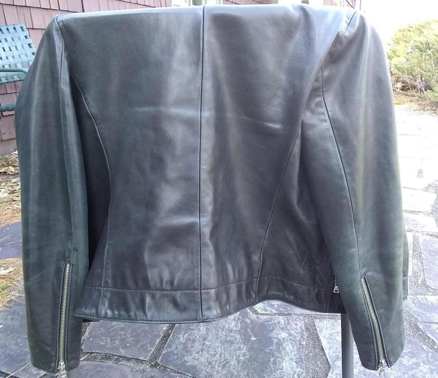 back of leather jacket hanging on chair